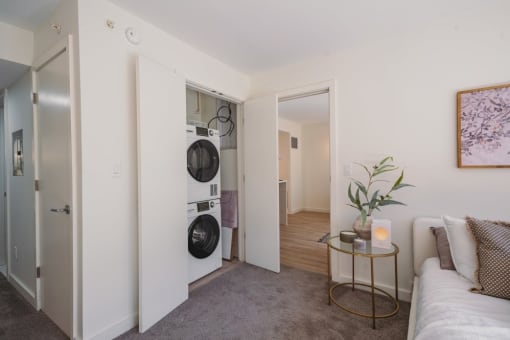 a living room with a washing machine and a dryer in it at Up House, Farmington, 06032