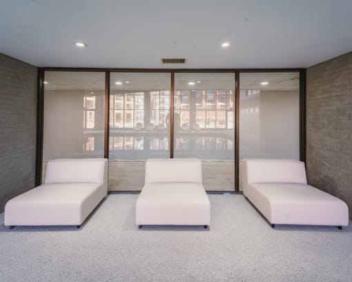 a room filled with white couches and a window at Up House, Farmington