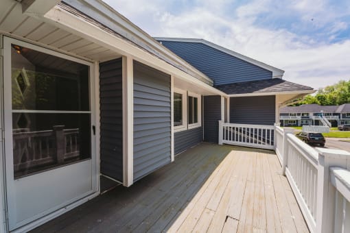 a house with a deck and a blue roof at Woodbury, Woodbury, CT, 06798
