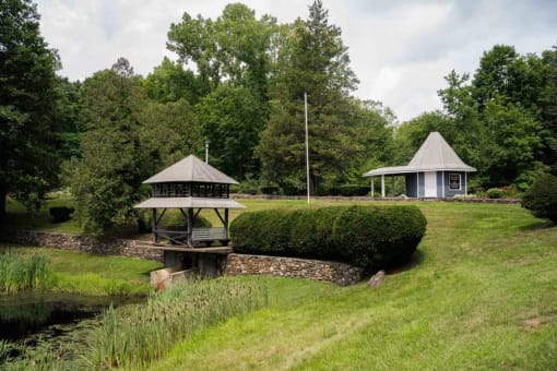 a gazebo and a pavilion in a park next to a river at Woodbury, Woodbury, CT