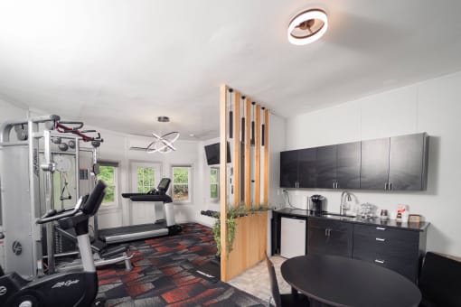 a home gym with a table and chairs and a work out area at Woodbury, Woodbury