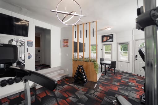 a living room that has a gym and a dining area with a table and chairs at Woodbury, Woodbury, 06798