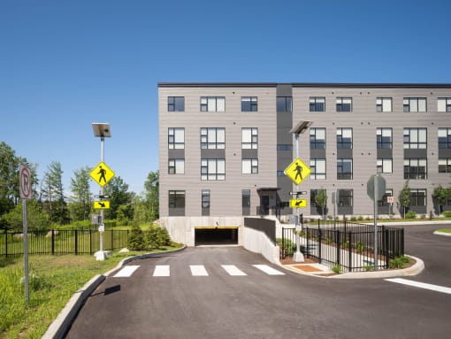 a building with a bridge and a road in front of it