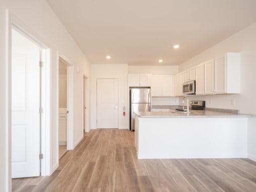 a kitchen with white cabinets and a white counter top
