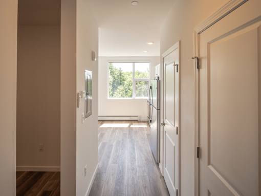 A long hallway with a door on the right.
