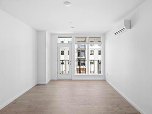 A white room with a sliding door and a window.