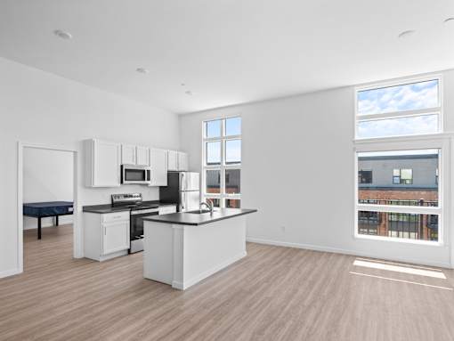 A kitchen with a large island and a view of the city.