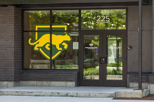The front of a building with a glass door and a sign that says 225.
