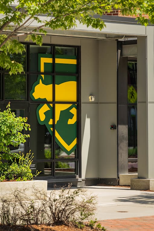 A green and yellow logo is on the front door of a building.