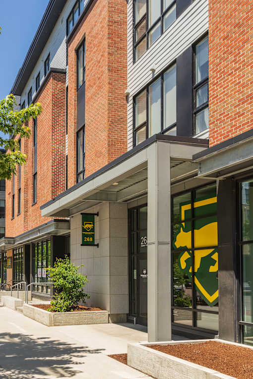 A building with a green and yellow logo on the front.
