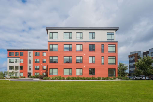 a brick building with a green lawn in front of it