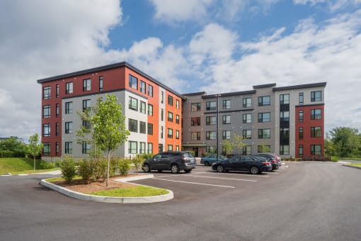 this is a picture of a parking lot with an apartment building in the background