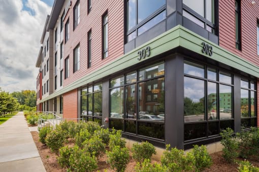a building with large windows and a green and red facade