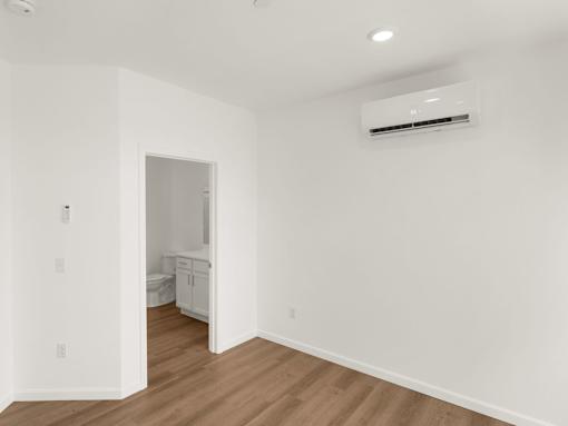 A room with a white wall and a window.
