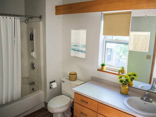 a bathroom with a toilet and a sink and a shower