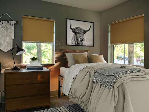 a bedroom with a bed and a picture of a bull