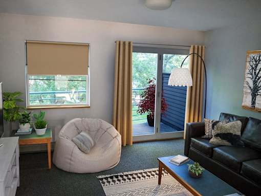 a living room with a couch and a chair and a sliding glass door