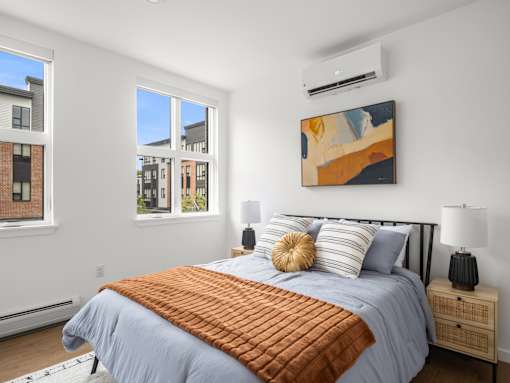 A bedroom with a large bed and a painting on the wall.