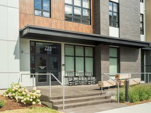 A modern building with a glass door and a number 223 on it.