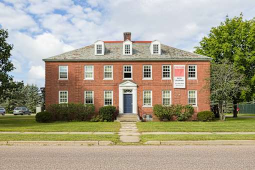 A red brick building with a sign on the front.