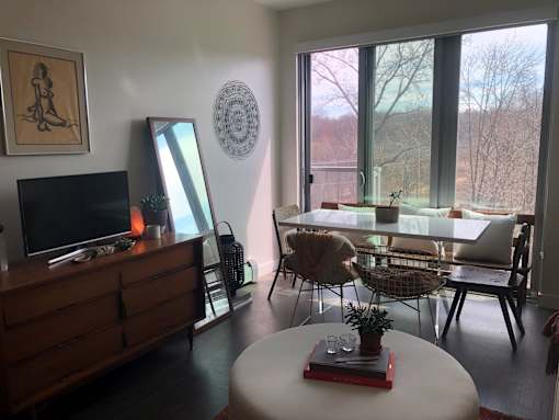 A living room with a white table and chairs.
