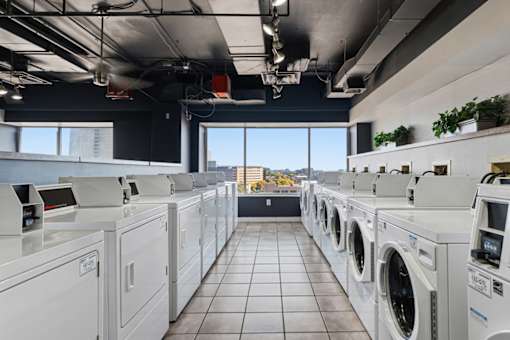 A row of washing machines in a laundromat.