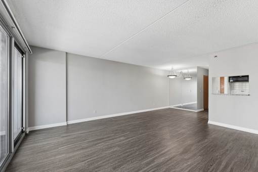A room with wooden flooring and white walls.