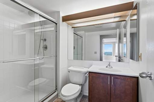 A white toilet sits next to a sink in a bathroom.