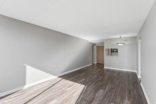 A room with a wooden floor and white walls.