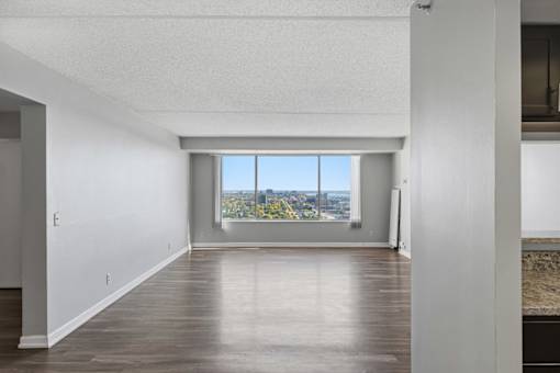 A room with a large window overlooking a cityscape.