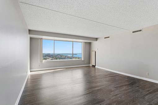 A room with a large window overlooking a cityscape.