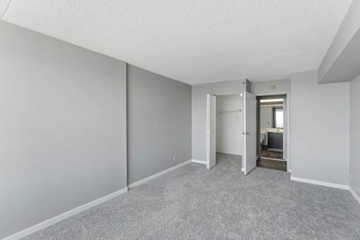 A room with a carpeted floor and white walls.