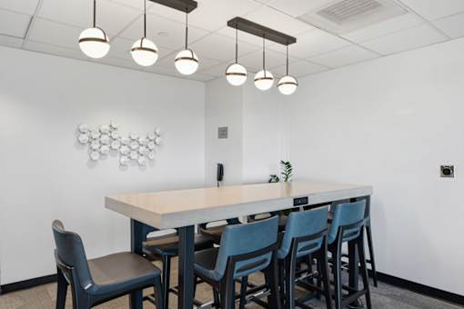 A conference room with a long table and chairs.
