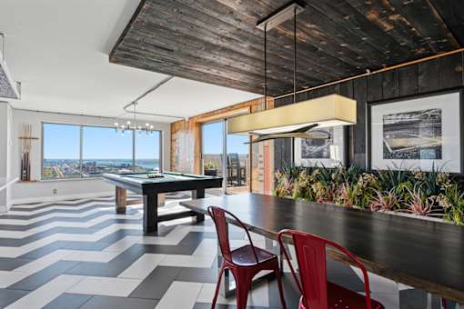 A dining room with a long table and chairs.