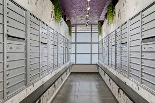 A long hallway with mailboxes on both sides.