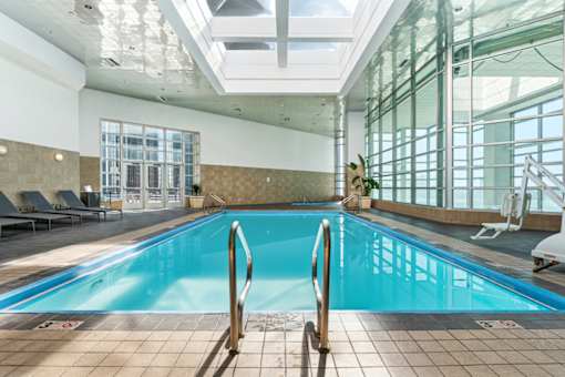 A large indoor swimming pool with a glass ceiling.