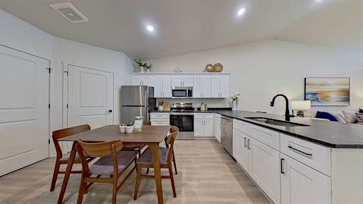 A photo of a modern open concept kitchen with an adjacent dining space