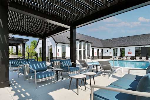 A pool area with chairs and tables is shown.