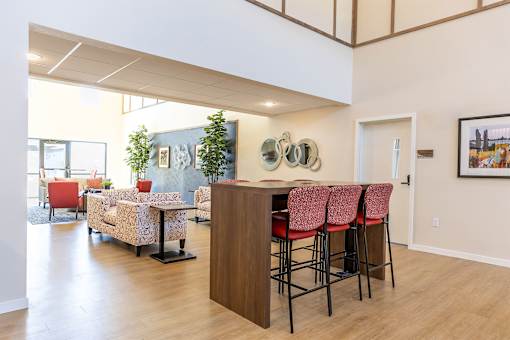 A room with a bar and chairs.