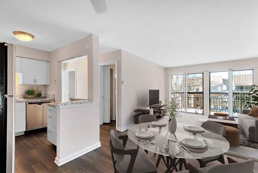 A modern kitchen with a dining table set for four.