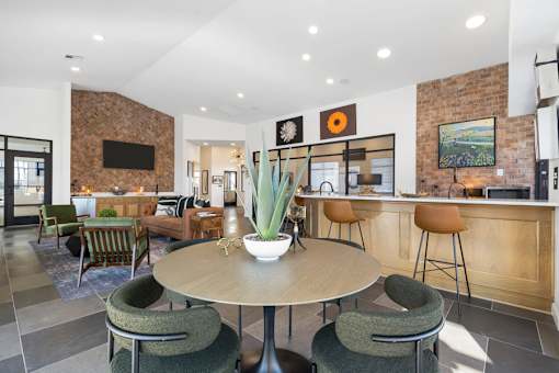 A modern dining room with a round table and chairs.