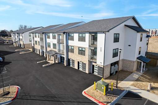 A parking lot in front of apartment buildings.