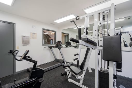 apartment fitness center with weight and cardio equipment