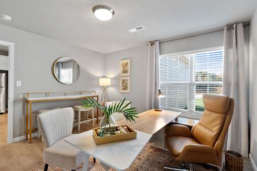 A modern dining room with a white table and chairs.