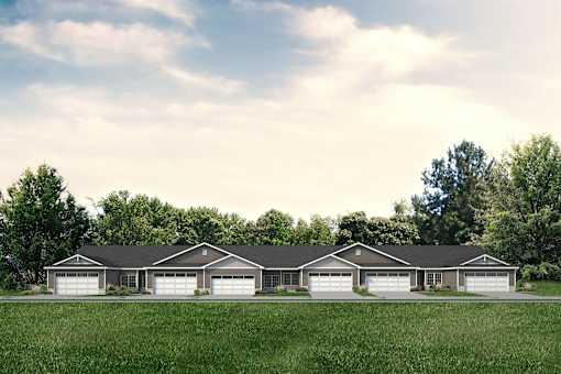 A row of houses with garages in front of them.