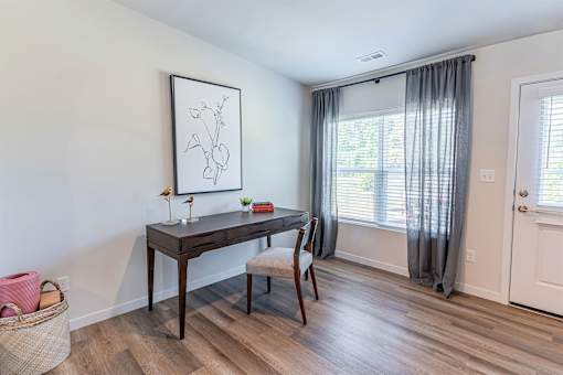 A room with a desk and chair in it.
