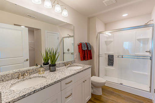 A bathroom with a white sink and a white toilet.