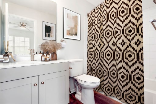 a bathroom with a black and white shower curtain