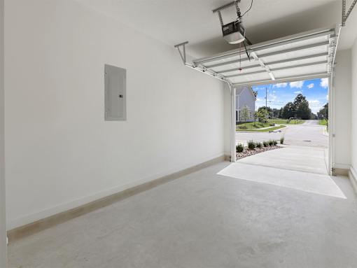 A white room with a window and a door leading outside.