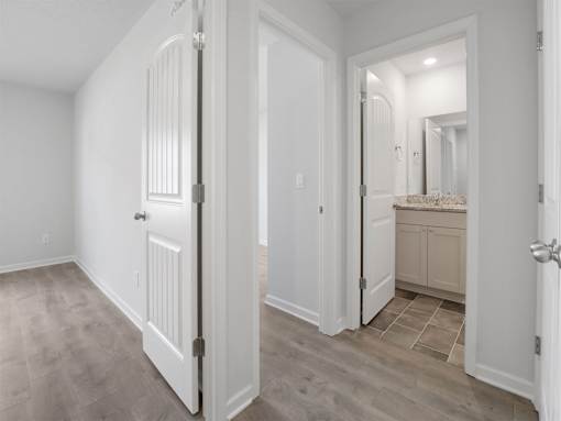 A white door is open to a bathroom.